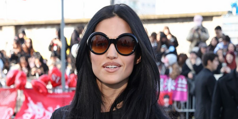 Model Gabbriette was seen wearing black Prada PR D08SU 16K10X round sunglasses with brown gradient lenses at the Prada Fall/Winter 2026 fashion show during Milan Fashion Week.