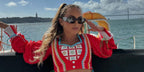 Cheerleader and influencer Gabi Butler was seen wearing black Prada PR 17WS 1AB5S0 Symbole Sunglasses while in Lisbon, shared on social media in  October 2024
