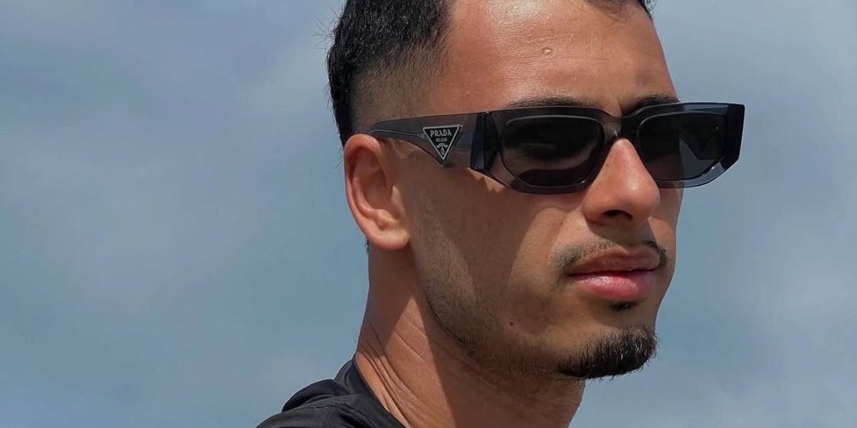 Brazilian footballer Gabriel Martinelli was seen wearing transparent grey Prada PR 09ZS 18S09T sunglasses in his Instagram story.