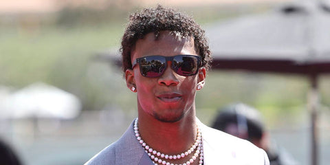 Garrett Wilson was seen wearing matte black Oakley Holbrook XL OO9417 05 sunglasses with prizm black lenses at the 2022 NFL Draft in Las Vegas, Nevada