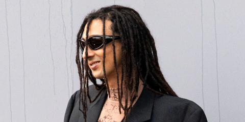 Italian rapper Ghali was seen wearing black Balenciaga BB0384S 001 wraparound sunglasses at the Balenciaga Spring/Summer 2026 fashion show during Paris Fashion Week.