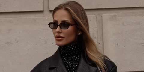 Swiss singer Ginta Biku was seen wearing brown mahogany Miu Miu MU 11ZS 21C40O rectangular sunglasses during Paris Fashion Week, season Spring/Summer 2026.