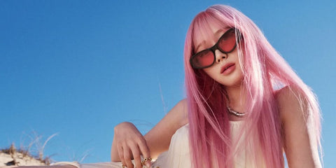 Japanese-Korean singer Giselle of girl band aespa was seen wearing black Loewe Signature LW40171U 01V cat eye sunglasses with red lenses in LOEWE Paula's Ibiza 2025 campaign, photographed by Gray Sorrenti.