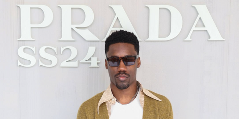 Giveon was seen wearing abstract orange Prada PR 19WS 06V40E square sunglasses to attend the Prada Menswear Spring/Summer 2024 during Milan Men's Fashion Week