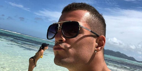 Swiss footballer Granit Xhaka was seen wearing silver Dita Mach One DRX 2030 E sunglasses with grey gradient lenses in a social media post.