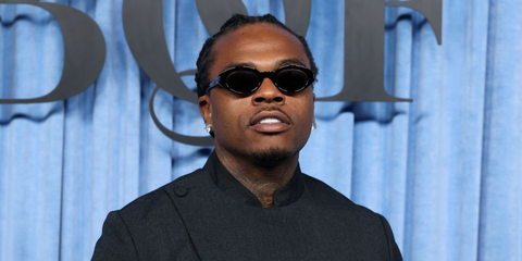 Gunna was seen wearing black Saint Laurent Sun SL 567 001 round oval sunglasses at the  BoF 500 Class of 2025 during Paris Fashion Week.