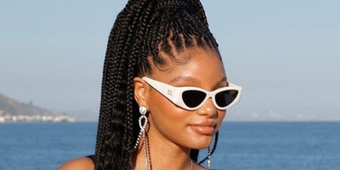 Halle Bailey was seen wearing white Miu Miu MU 06YS 1425S0 cat eye sunglasses at the Miu Miu Supper Club Malibu in JUly 2023