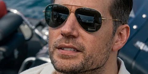 Henry Cavill was seen wearing gold Ray-Ban Aviator Reverse RB R0101S 001/VR sunglasses in 2026 film In The Grey.