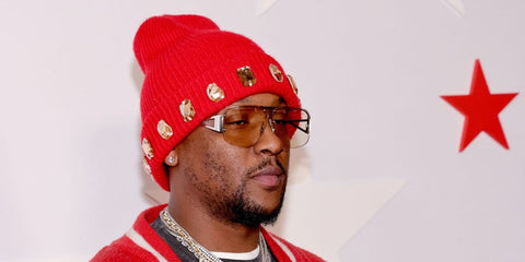 Rapper and record producer Hit-Boy was seen wearing silver Bottega Veneta BV1065S 006 sunglasses with light brown lenses at the NBA All-Star Legendary Tip-Off Celebration in Los Angeles, February 2026.