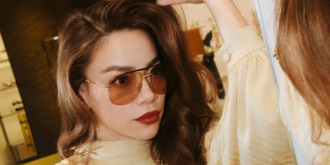 Vietnamese singer Ho Ngoc Ha was seen wearing gold Gucci GG2165S 002 aviator sunglasses with light brown lenses in her social media post, December 2025.