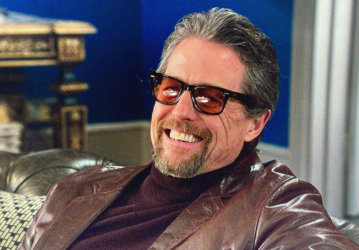 Hugh Grant was seen wearing black Ray-Ban Wayfarer RB 2140 1294/33 sunglasses with brown lenses in his movie The Gentlemen