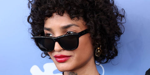Actress Indya Moore was seen wearing black Saint Laurent Sun SL 816 001 sunglasses at the Venice Film Festival 2025. Shop online now on Pretavoir