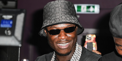 Rapper J Hus was seen wearing black Prada PR B54S 1AB5Z1 Polarised rectangular sunglasses at the Wireless After Party in London, July 2025.