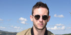 JBritish actor Jamie Bell was seen wearing black and gold Garrett Leight Wilson 4003 MBK-MST/PGY round sunglasses at the Telluride Film Festival