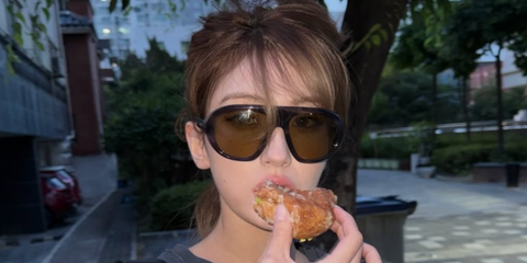 Canadian-South Korean singer Jeon Somi was seen wearing striped Prada PR C05S 23G70G sunglasses with green lenses in her Instagram post, June 2026.