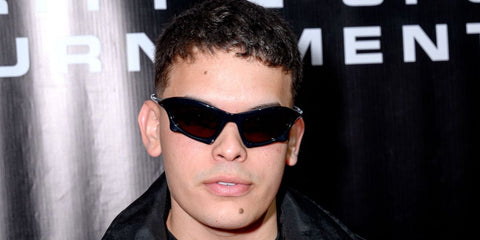 Producer Jeremy Ayala (son of Daddy Yankee) was seen wearing black Balenciaga BB0229S 001  sculptural sunglasses at the N16 Racing Celebrity E-Sports Tournament in Miami, May 2023.