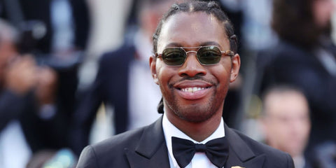 Playwright and actor Jeremy O. Harris was seen wearing gold and tortoiseshell Garrett Leight Goldie 4064 G-BIO BTO/PALM sunglasses with green lenses at the 2023 Cannes Film Festival