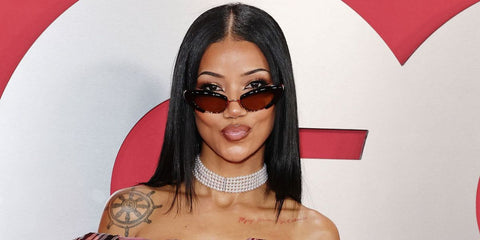 Jhene AIko was seen wearing black Bottega Veneta BV1387S 001 cat eye sunglasses with yellow lenses at the GQ Men Of The Year Awards 2025.