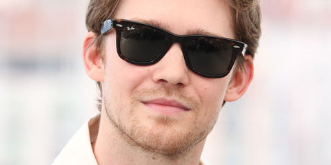 Joe Alwyn wears Ray-Ban Wayfarer 2140 902 sunglasses at the Cannes Film Festival 2022