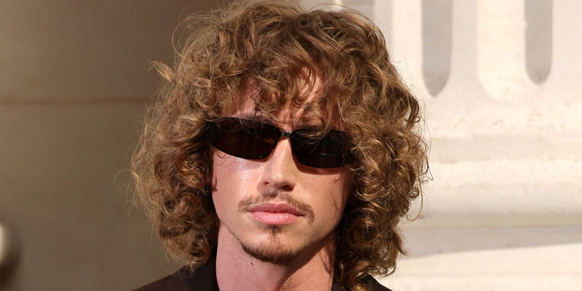 Model and creator Jordan Huxhold was seen wearing black Saint Laurent Sun SL 963 001wraparound sunglasses at the Saint Laurent Menswear Spring/Summer 2027 fashion show during Paris Men's Fashion Week