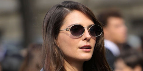 French actress Josephine Japy was seen wearing pale gold Miu Miu MU 52YS ZVN5D1 oval sunglasses with grey lenses at the Miu Miu Spring/Summer 2024 fashion show during Paris Fashion Week