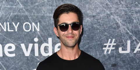 Actor Josh Peck was seen wearing rubber black Ray-Ban Erika 4171 6228G round sunglasses at the premiere of "Tom Clancy's Jack Ryan" during Los Angeles Fleet Week 2018.