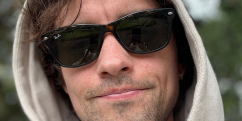 Celebrity actor and musician Josh Whitehouse was seen wearing tortoiseshell Ray-Ban New Wayfarer RB 2132 902 sunglasses with green lenses in his Spotify profile.