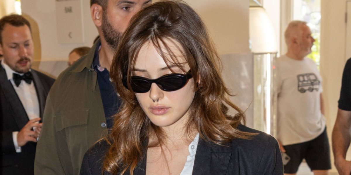 Australian actress Katherine Langford was seen wearing black Prada PR 26ZS 16K08Z cat eye sunglasses at the Cannes Film Festival 2024. Shop online now on Pretavoir
