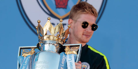 Kevin De Bruyne was seen wearing gold Ray-Ban Round Metal RB 3447N 001 sunglasses