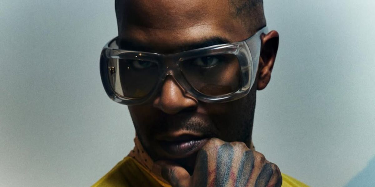 Rapper Kid Cudi was seen wearing transparent Saint Laurent Sun SL 902 HOWL 002 pillowed sunglasses in a Vogue France feature, April 2026.