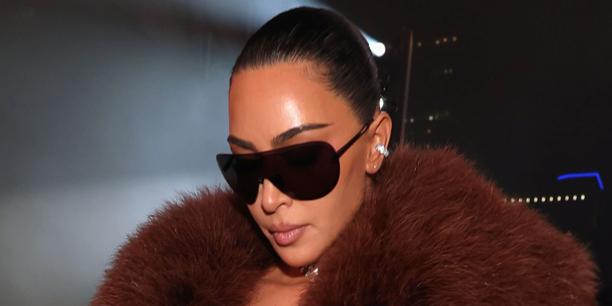 Kim Kardashian was seen wearing black Gucci GG2271S 001 shield sunglasses at the Gucci Cruise 2027 fashion show in Times Square, New York City