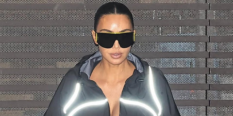 Kim Kardashian was seen wearing black and yellow Loewe Signature LW40202U 02A Speed Shield sunglasses at Scott Disick's birthday party in Malibu, May 2026.