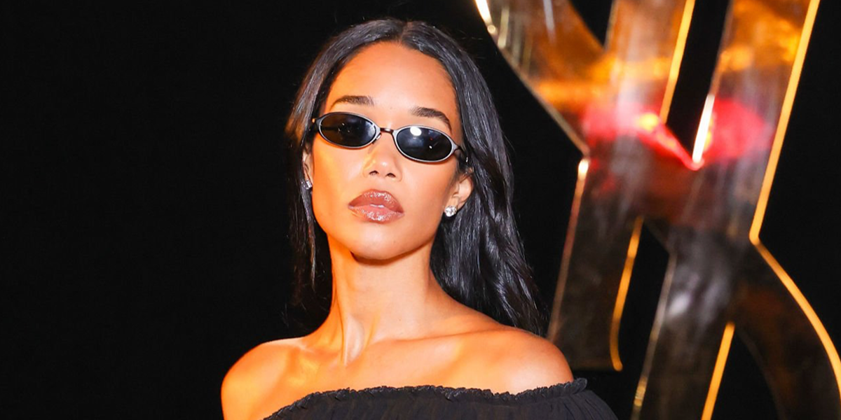 Laura Harrier wore black Saint Laurent Sun SL 935 001 oval sunglasses at the Saint Laurent Spring Summer 2027 show during Paris Fashion Week.