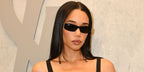 Laura Harrier was seen wearing black Saint Laurent Sun SL M152 001 sunglasses at the YSL Beauty Drive-Thru and Beauty Stage opening event during Coachella Music Festival 2026 weekend.
