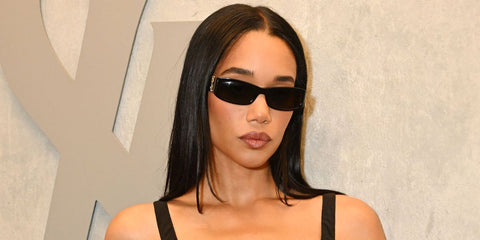 Laura Harrier was seen wearing black Saint Laurent Sun SL M152 001 sunglasses at the YSL Beauty Drive-Thru and Beauty Stage opening event during Coachella Music Festival 2026 weekend.