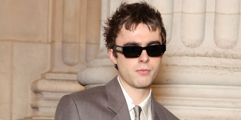 Lennon Gallagher, musician and model son of Liam Gallagher, was seen wearing black Saint Laurent Sun SL 660 001 sunglasses at the Saint Laurent Menswear Fall/Winter 2025 fashion show during Paris Men's Fashion Week