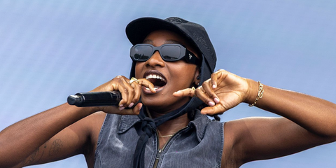 Rapper and singer Little Simz was seen wearing black Prada PR 17WS 1AB5S0 Symbole Sunglasses onstage at the Sziget Festival 2025 in Budapest. Shop online now on Pretavoir