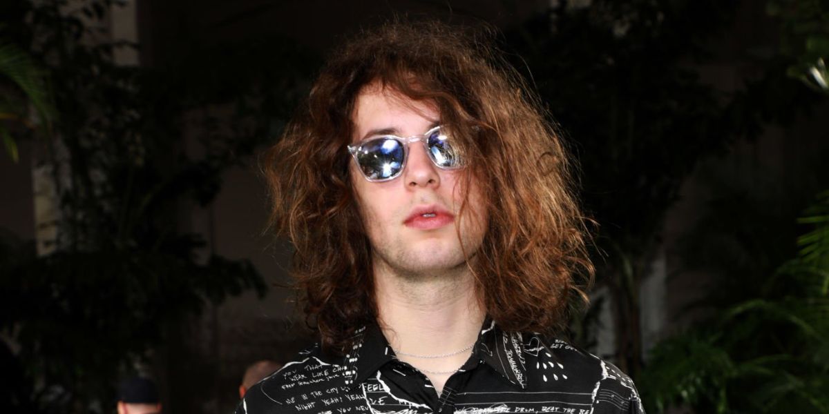 Mick Jagger's son Lucas Jagger was seen wearing transparent Saint Laurent Sun SL 28 012 sunglasses with silver mirror lenses at the Amiri Menswear fashion show during Paris Men's Fashion Week