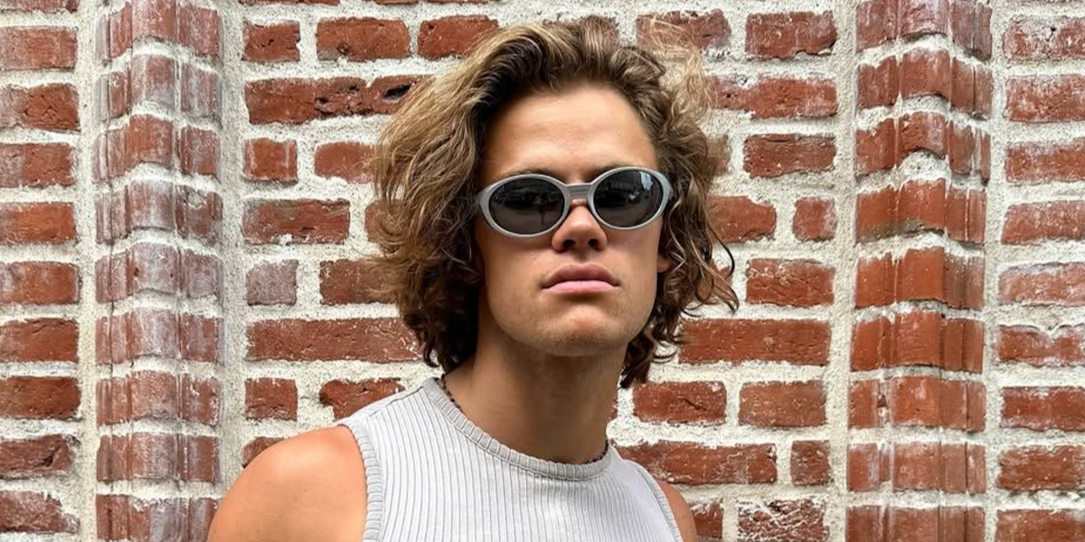 Norwegian-Brazilian alpine ski racer Lucas Pinheiro Braathen was seen wearing grey silver Oakley Eye Jacket Redux OO9438 05 Prizm Polarised sunglasses in an NSS Sports feature, December 2025.