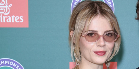 Lucy Boynton was seen wearing pink Miu Miu MU 04ZS 20I60V oval sunglasses with pink lenses at the Wimbledon Tennis Championships 2026.