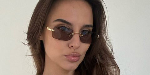 Reality television star Lucy Watson of Made In Chelsea was seen wearing gold Miu Miu MU B50S 5AK20I rimless sunglasses with brown purple lenses in her Instagram post, April 2026.