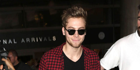 Australian singer and musician Luke Hemmings of 5 Seconds of Summer was seen wearing the iconic Ray-Ban Clubmaster 3016 W0365 Black sunglasses in Los Angeles, July 2015.