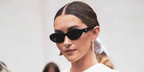 British-American model Madeleine White was seen wearing black Prada PR 26ZS 16K08Z cat eye sunglasses at the Prada Spring/Summer 2024 fashion show during Milan Fashion Week