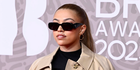Singer-songwriter Mahalia was seen wearing black Prada PR 17WS 1AB5S0 Symbole Sunglasses at The BRIT Awards 2023.