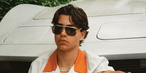 Actor Malachi Barton was seen wearing gold Tom Ford Stavros TF1204 30N sunglasses with grey lenses in a Flaunt Magazine feature, August 2026.
