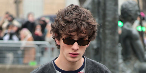 Russian lead actor of Anora, Mark Eydelshteyn was seen wearing tortoiseshell Miu Miu MU A06S 14L09Z sunglasses with brown lenses at the Miu Miu Fall/Winter 2025 fashion show during Paris Fashion Week. Shop online now on Pretavoir