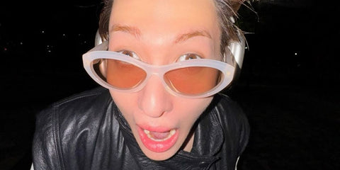 South Korean singer Martin of K-Pop group CORTIS was seen wearing opaline white Prada PR 26ZS 12V4I2 cat eye sunglasses with brown lenses in his Instagram post, November 2025.