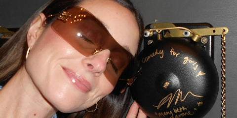 Comedian Mary Beth Barone was seen wearing gold Miu Miu MU B53S 5AK20P rimless sunglasses with bronze lenses in her Instagram post, February 2026