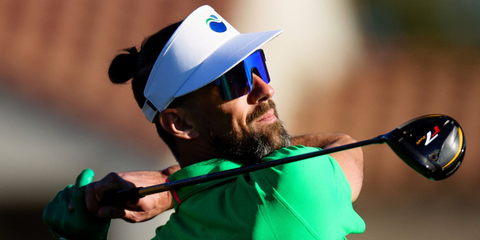 Former competitive swimmer and Olympic medalist Michael. Phelps was seen wearing navy blue Oakley Sutro Lite OO9463 06 sunglasses with Prizm sapphire lenses at the WM Phoenix Open golf competition 2026