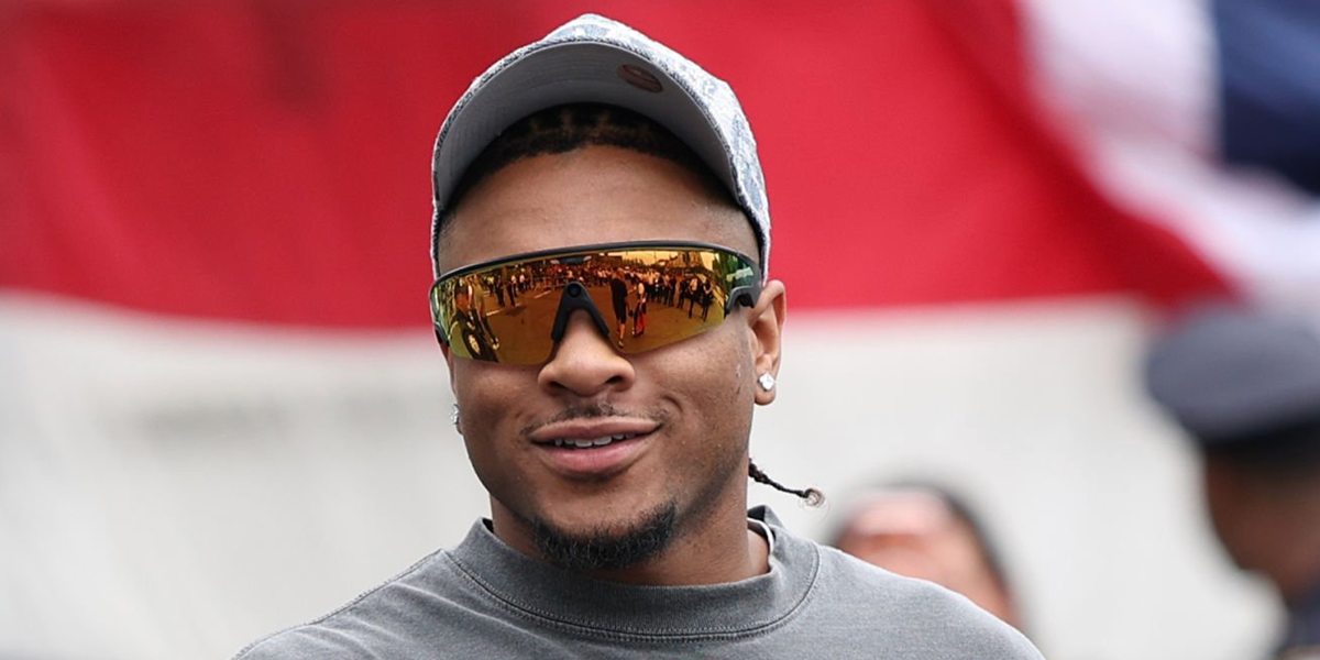 Basketball player Miles McBride was seen wearing black Oakley Meta Vanguard OW8001 04 Smart Glasses with Prizm 24k lenses at the New York Knicks 2026 Parade.